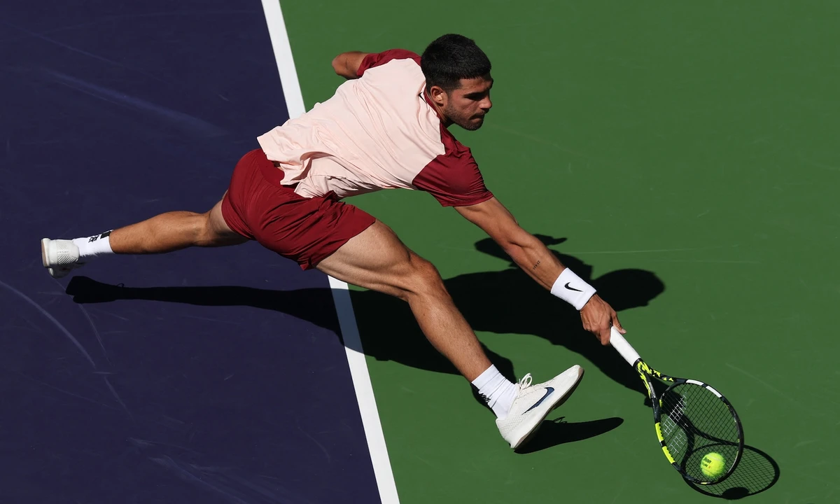 Carlos Alcaraz of Spain stretches to play a backhand volley against Quentin Halys of France in their second round match during the BNP Paribas Open at Indian Wells Tennis Garden on March 8, 2025 in Indian Wells, California. (AFP)
