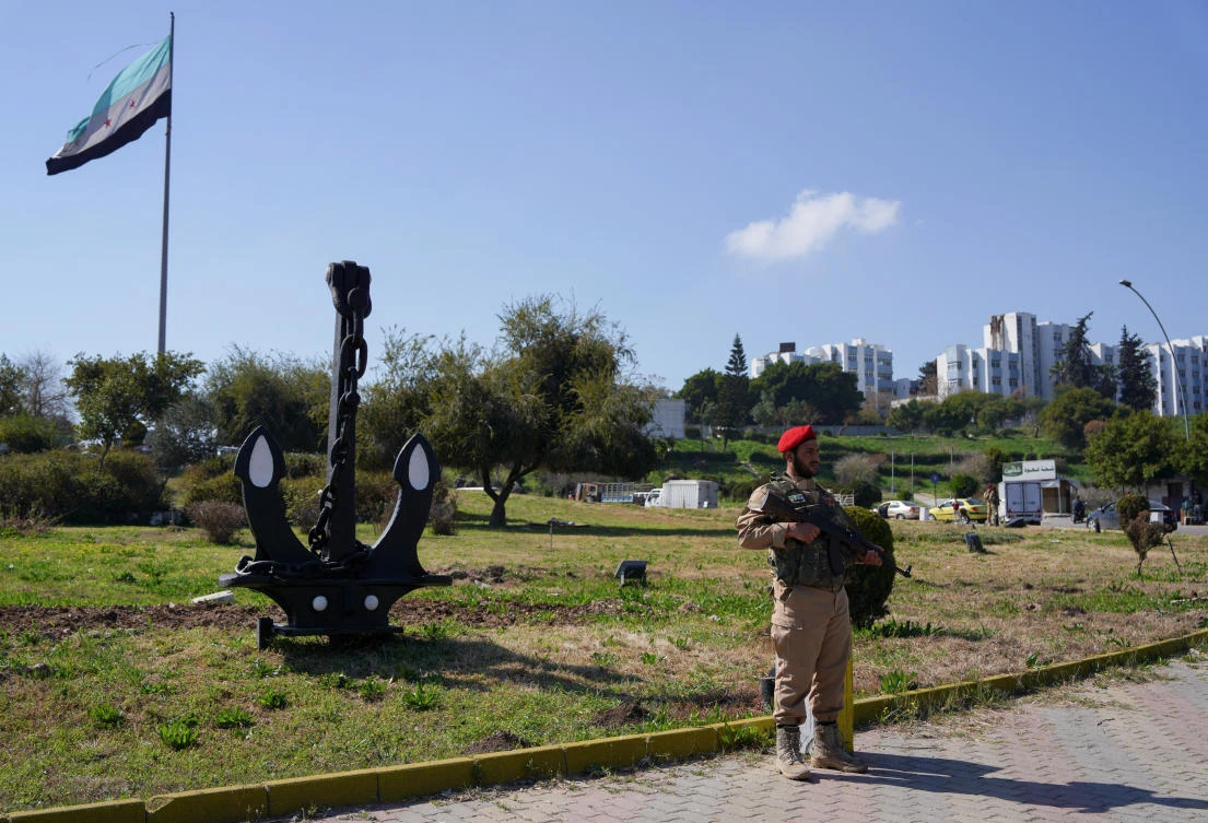 A member of Syrian security forces stands guard, as Syria’s interim President Ahmed Al-Sharaa grapples with the fallout from reported mass killings of Alawite minority members, in Latakia, Mar. 11, 2025. (Reuters)