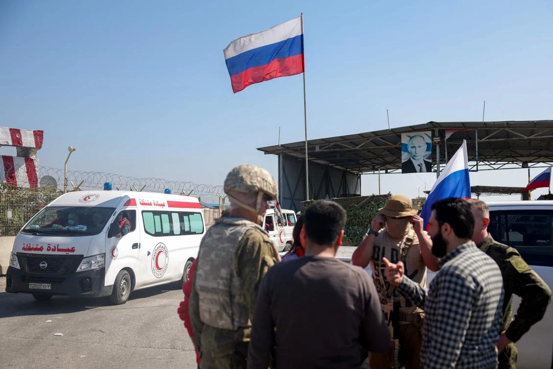 Syrian Red Crescent vehicles evacuate wounded civilians who took refuge from violence in the Hmeimim Russian base in Syria's Latakia Mediterranean province, March 11, 2025. (AFP)