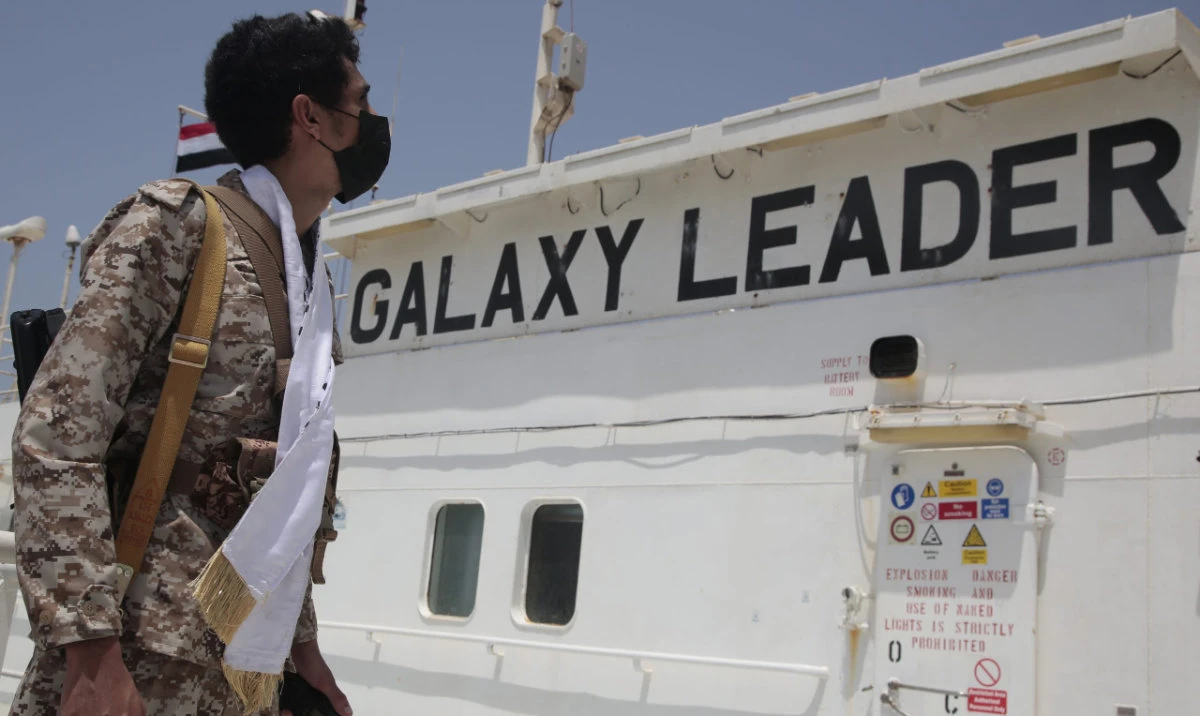 A Houthi soldier stands alert on board of the Israeli Galaxy ship which was seized by the Houthis, in the port of Saleef, near Hodeidah, Yemen. (File/AP)