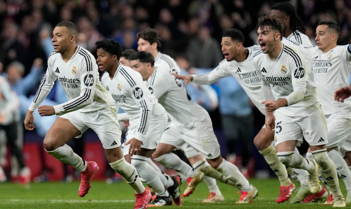 Real Madrid players celebrate after winning the penalty shootout during the Champions League round of 16, second leg, soccer match between Atletico Madrid and Real Madrid at the Metropolitano stadium in Madrid, Spain, Wednesday, March 12, 2025. (AP)