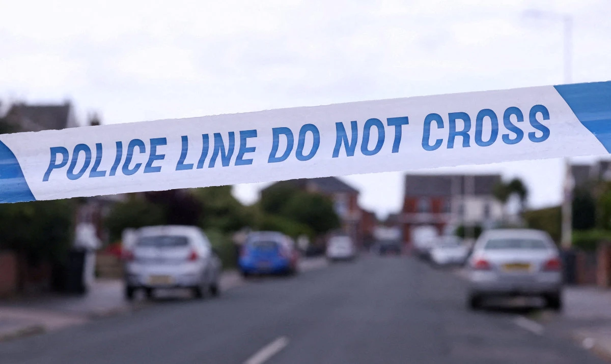 Police tape outlines a perimeter, in Maple street, near a tribute for the victims of a knife attack in Southport, Britain. (Reuters/File)