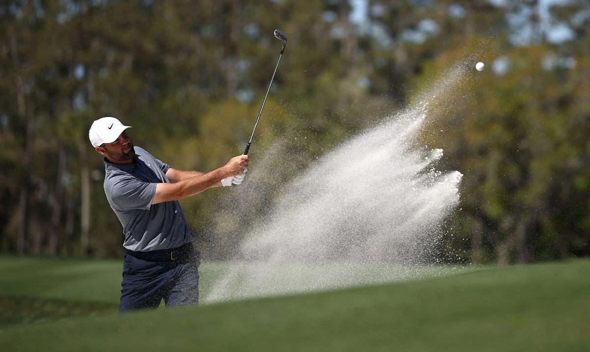 Scottie Scheffler of the US plays a shot from a bunker on the seventh hole during a practice round at the Players Championship on the Stadium Course at TPC Sawgrass on Wednesday in Ponte Vedra Beach, Florida. (AFP)