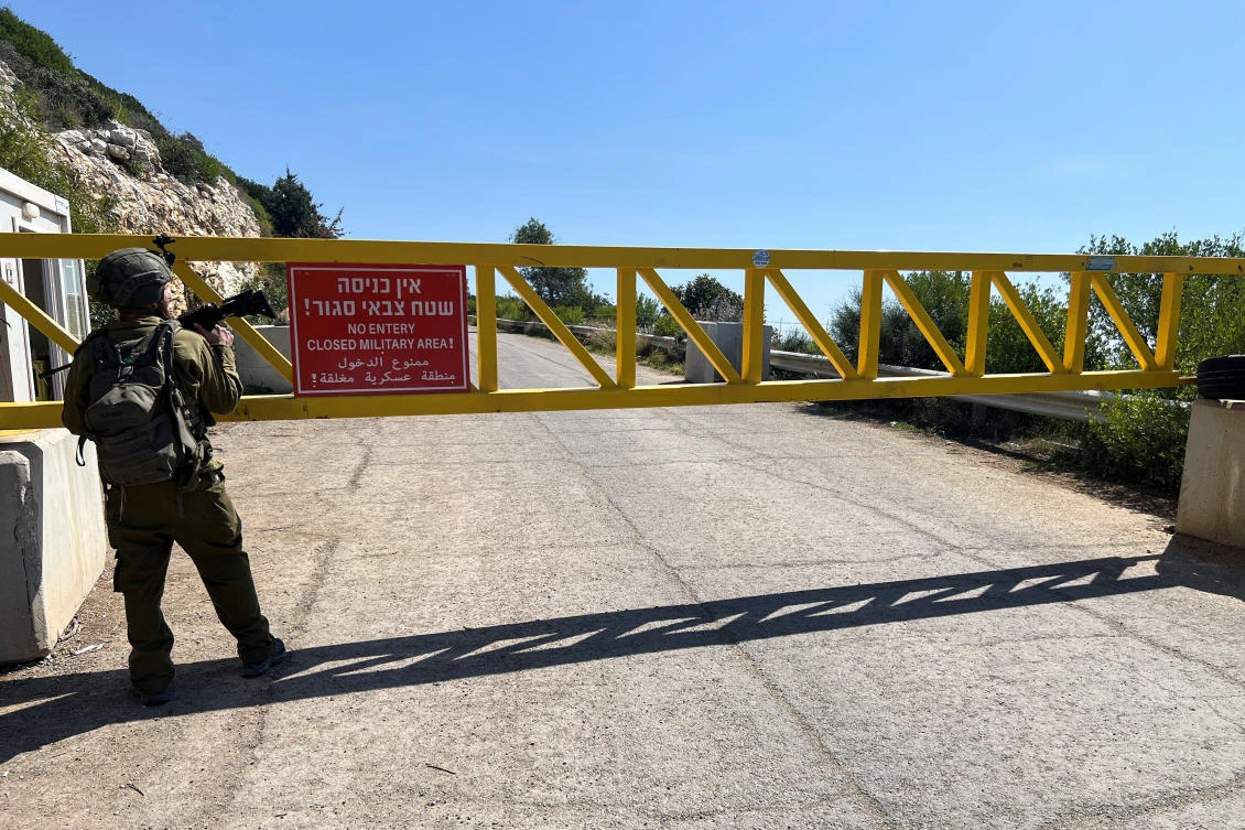 An Israeli soldier stands next to a gate on a road near the Israel-Lebanon border, in Israel, March 12, 2025. (REUTERS)