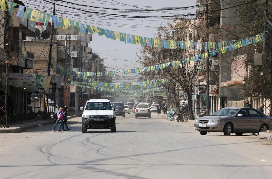 People cross a street, after the Kurdish-led and US-backed Syrian Democratic Forces (SDF), which controls much of Syria's oil-rich northeast, signed a deal agreeing to integrate into Syria's new state institutions, March 11, 2025. (REUTERS)