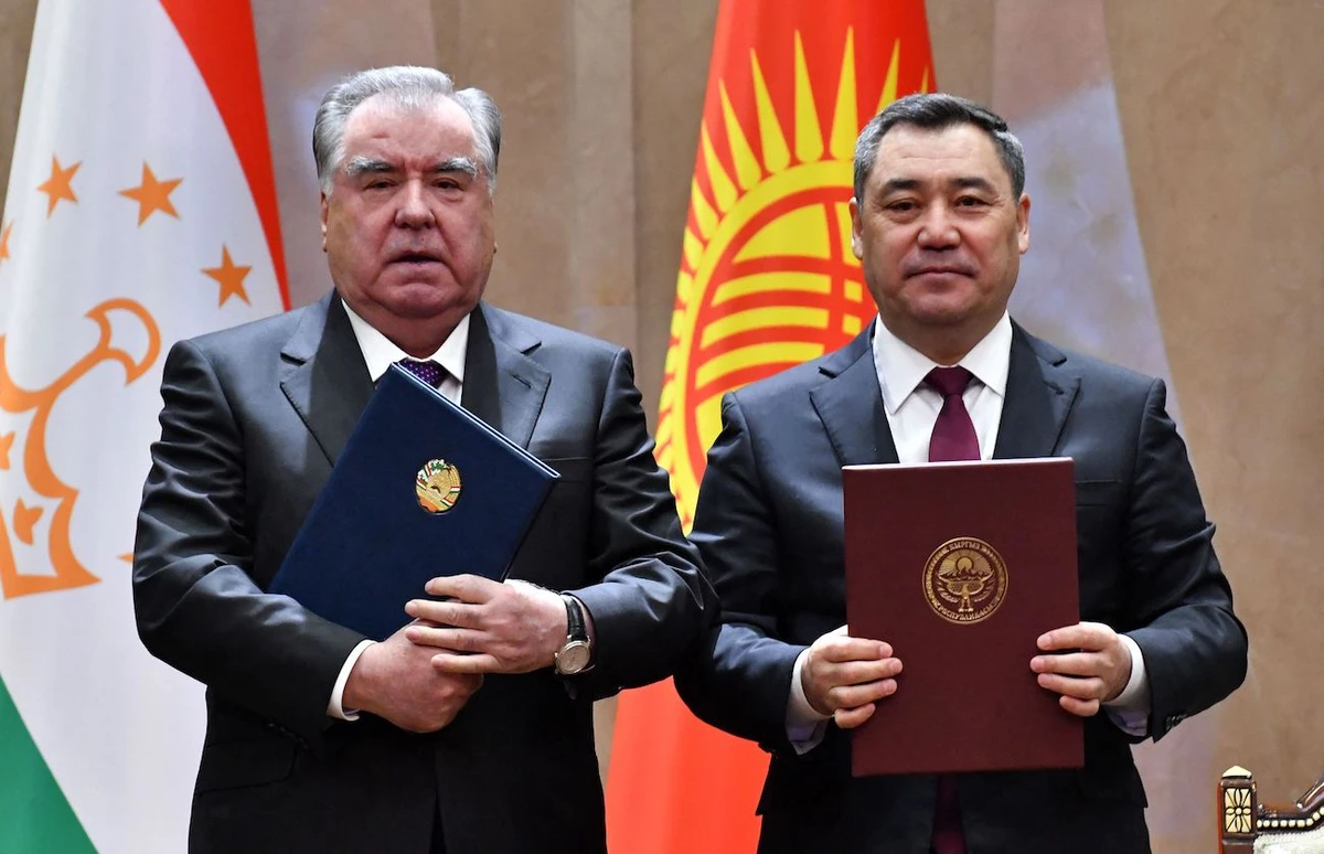 Kyrgyz President Sadyr Japarov and his Tajik counterpart Emomali Rakhmon pose with signed documents during their meeting at the Yntymak Ordo state residence in Bishkek on March 13, 2025. (AFP)