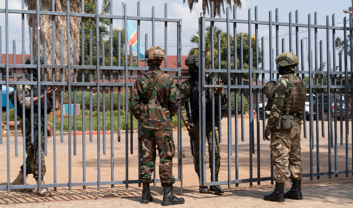 Members of the M23 movement stand at the gate of the local government offices in Bukavu on March 1, 2025. (AFP/File)