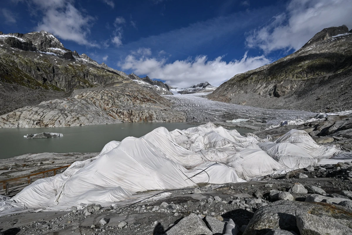 This photograph shows a view of some insulating fabric covering a small part of the Rhone Glacier to prevent it from melting, near Gletsch, in the Swiss Alps, on September 30, 2024. A snowy winter provided no respite for Switzerland's glaciers, which shed 2.4 percent of their volume over the past year, with sand blown in from the Sahara accelerating the summer melt. (AFP/File)