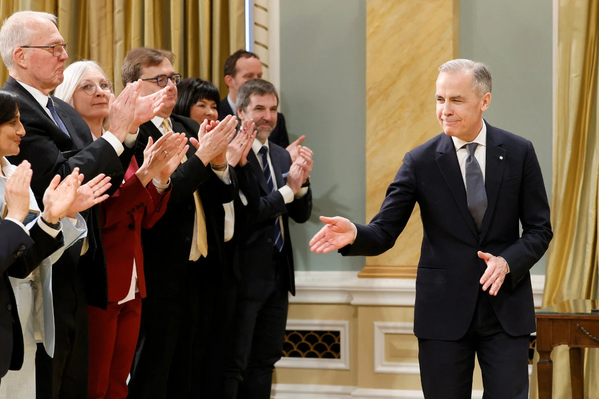 Leader of the Liberal Party of Canada Mark Carney is applauded by members of his government during his swearing-in ceremony as Canada's next prime minister at an event in Ottawa, Ontario, on March 14, 2025. (REUTERS)