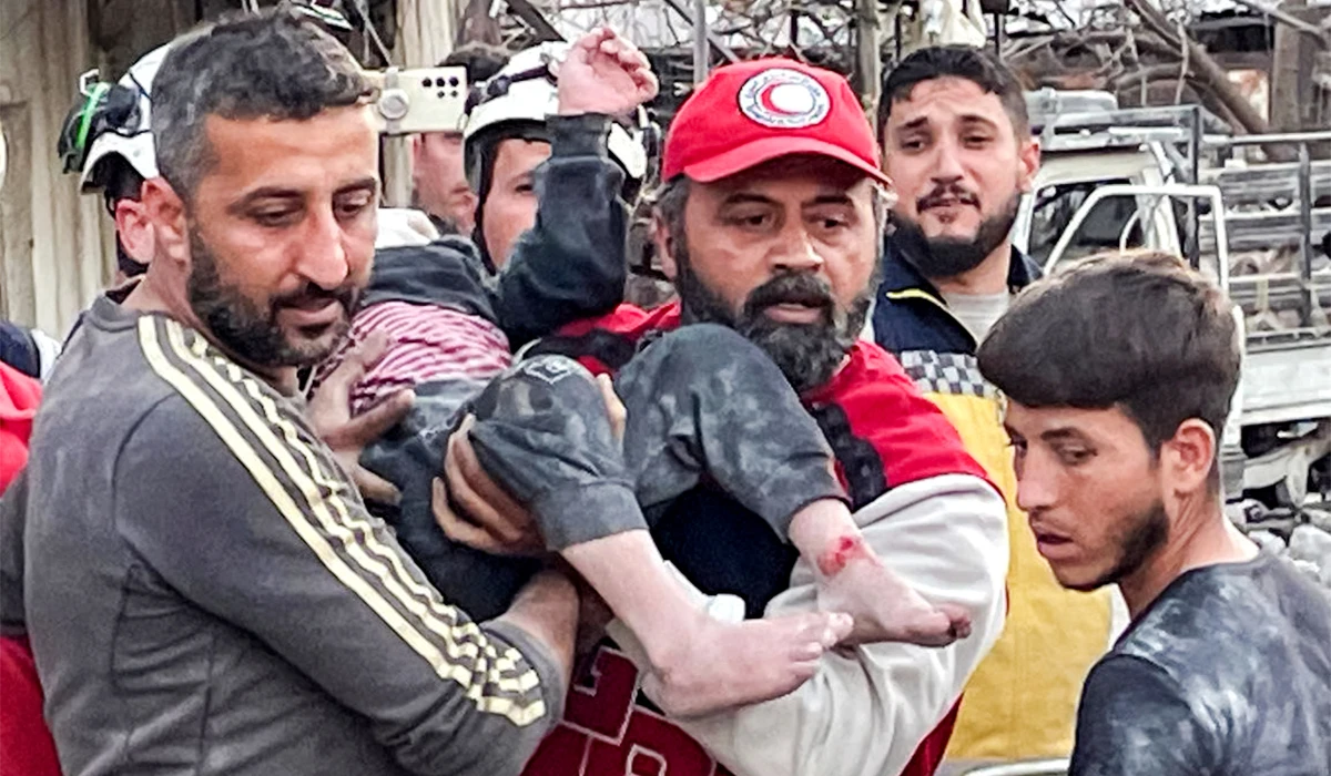 This handout picture released by the Syrian Arab News Agency (SANA) shows Syrian civil defence members and first responders rescuing a young victim from the site of an explosion in Syria's western coastal city of Latakia on March 15, 2025. (AFP)
