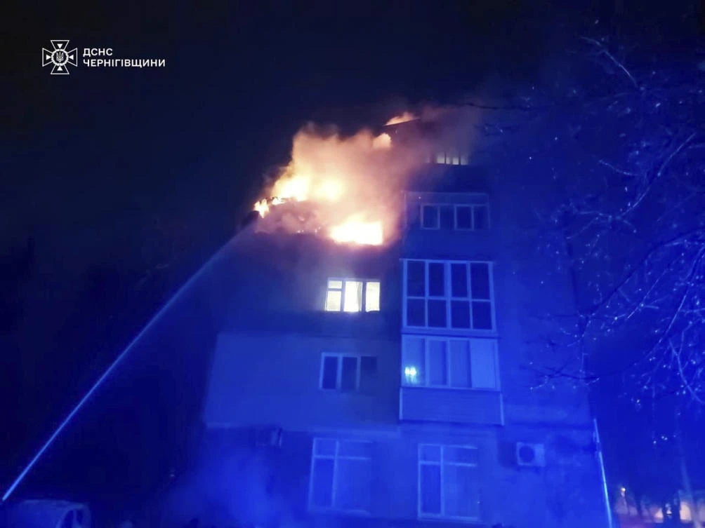 In this photo provided by the Ukrainian Emergency Service, firefighters put out a fire at a apartment building following a Russian drone attack in Chernihiv, Ukraine, Sunday, March 16, 2025. (Ukrainian Emergency Service via AP)