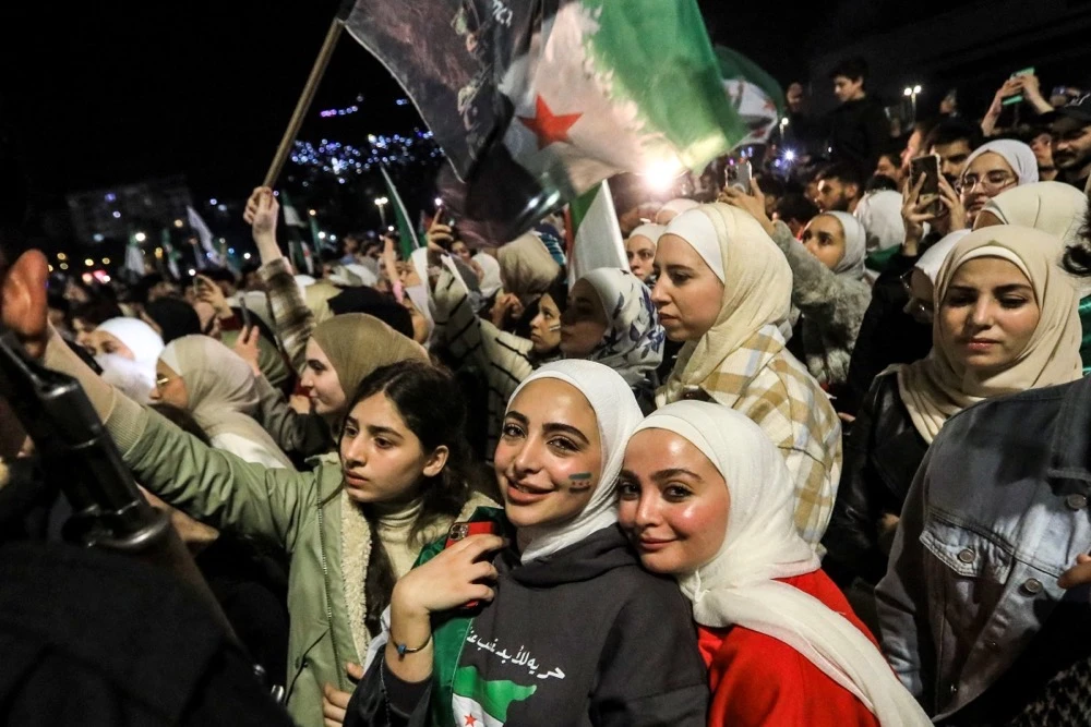 Syrians gathered in Damascus on March 15 to commemorate the 14th anniversary of the uprising against Bashar Assad. (AFP)