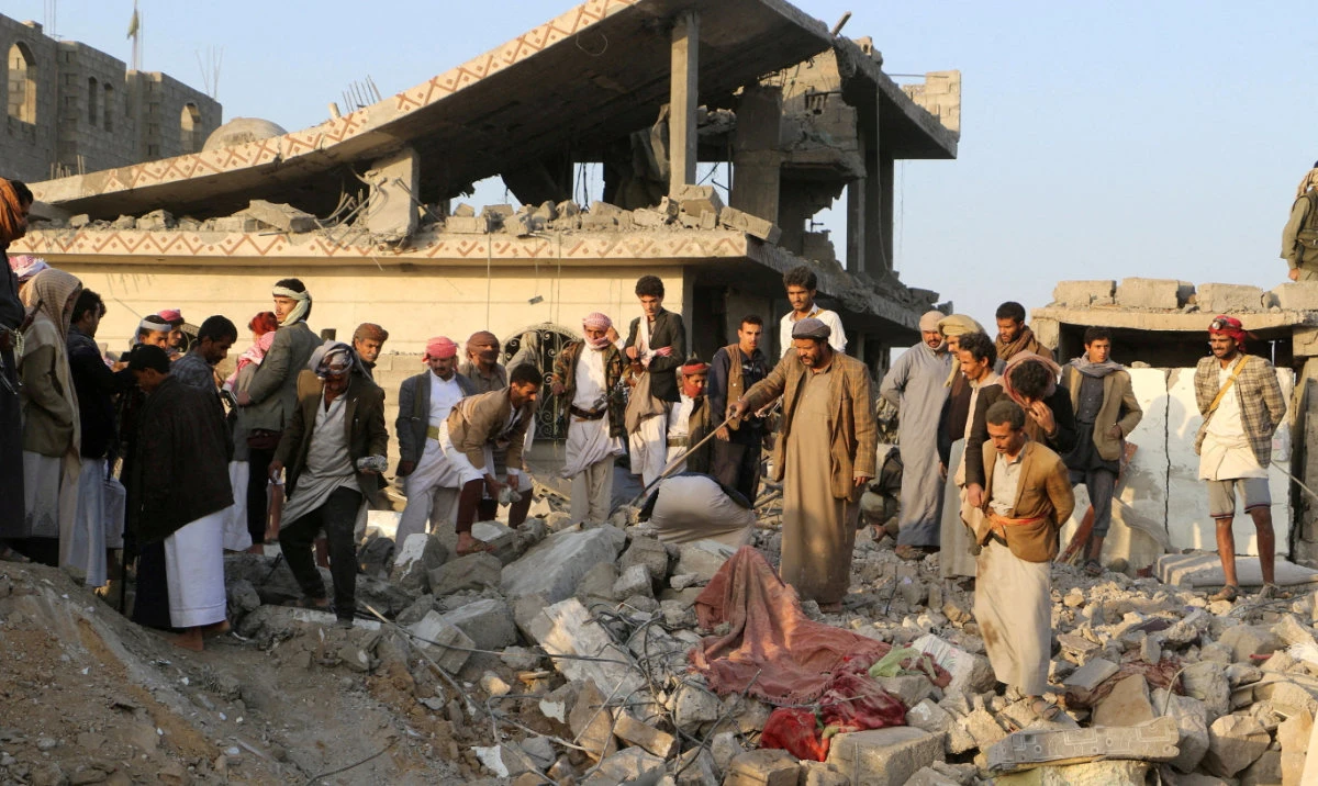 People gather on the rubble of a house hit by a US strike in Saada, Yemen March 16, 2025. (Reuters)