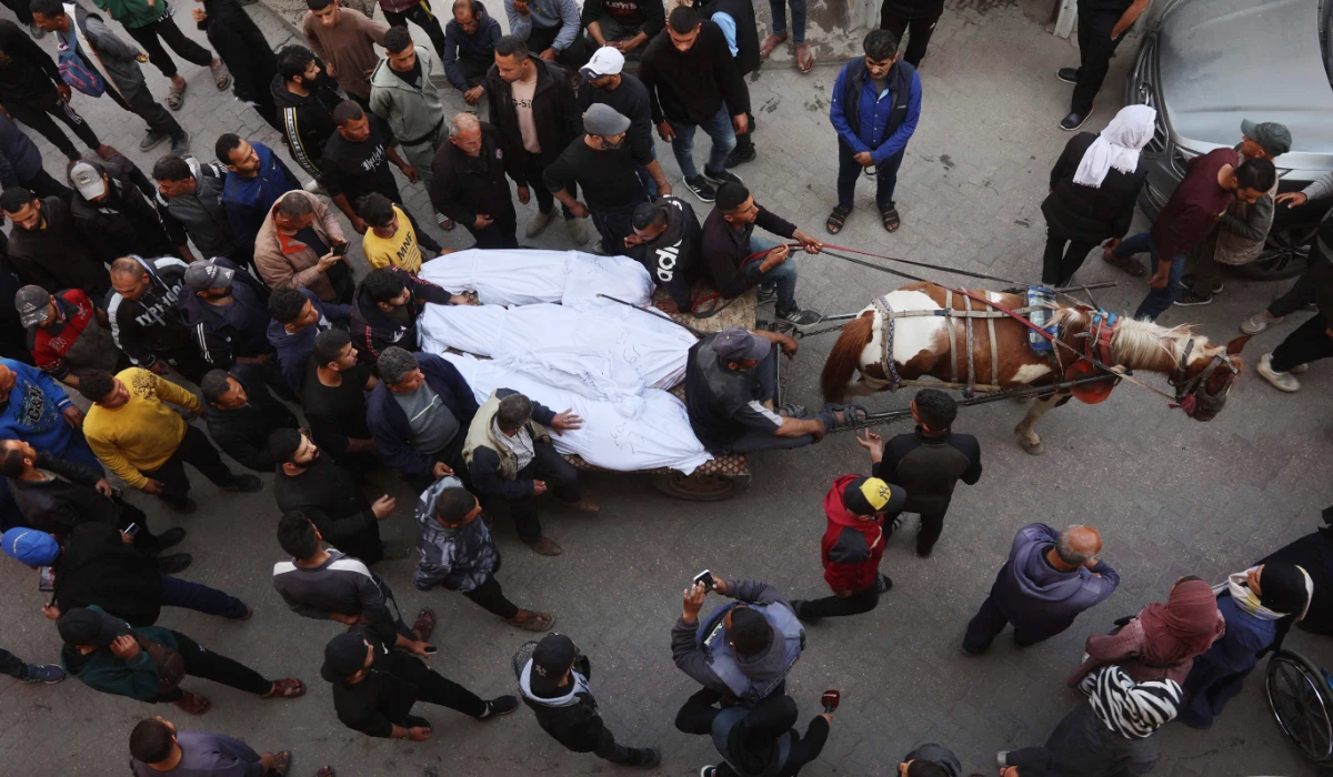 The bodies of victims killed in overnight Israeli airstrikes on the Gaza Strip are carried on a horse cart outside Al-Ahli Arab hospital, also known as the Baptist hospital, in Gaza City ahead of their burial on March 18, 2025. (AFP)