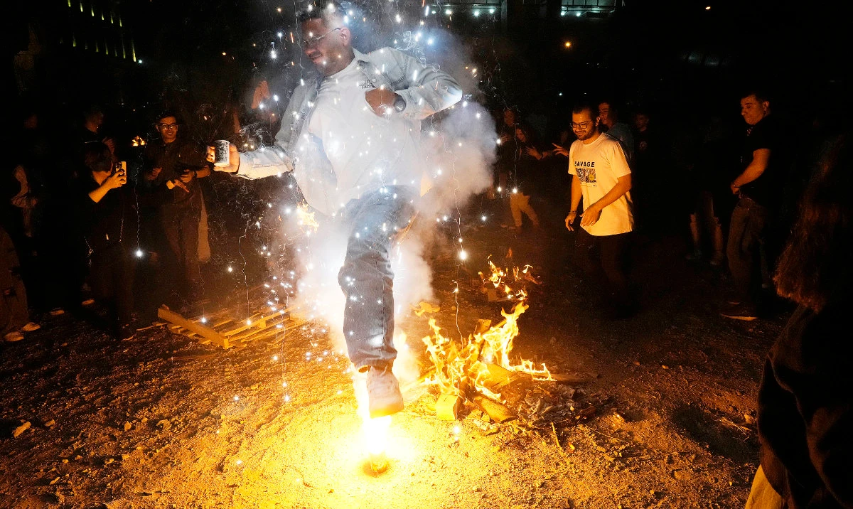 A man in Tehran jumps over a firework celebrating Chaharshanbe Souri, or Wednesday Feast, an ancient festival of fire on the eve of the last Wednesday of the Persian year. (AP)