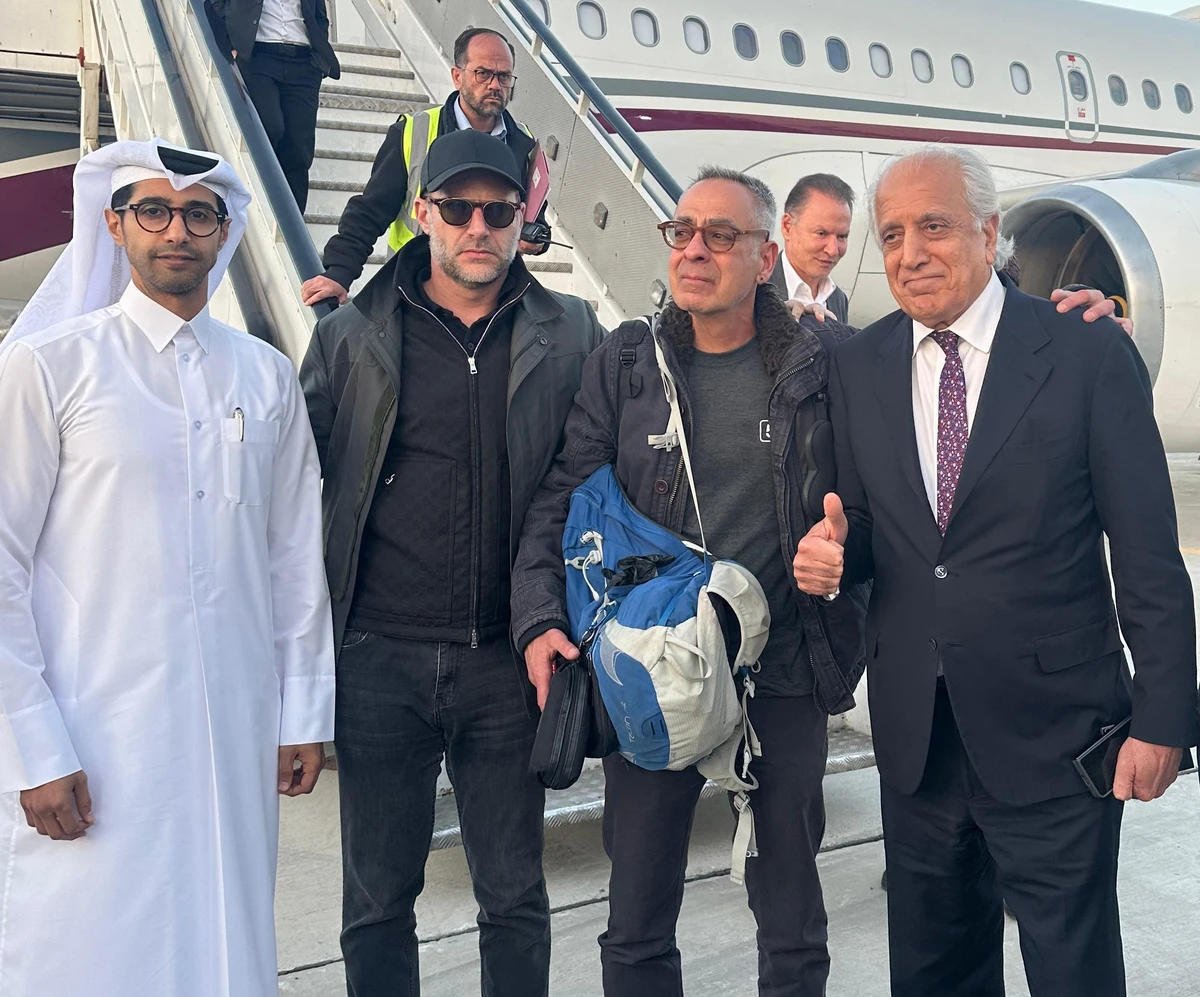 US citizen George Glezmann (C) posing for a picture with US official Adam Boehler (C-L), former US envoy to Afghanistan Zalmay Khalilzad (C-R), and Qatari diplomats in Kabul, Mar. 20, 2025. (AFP)