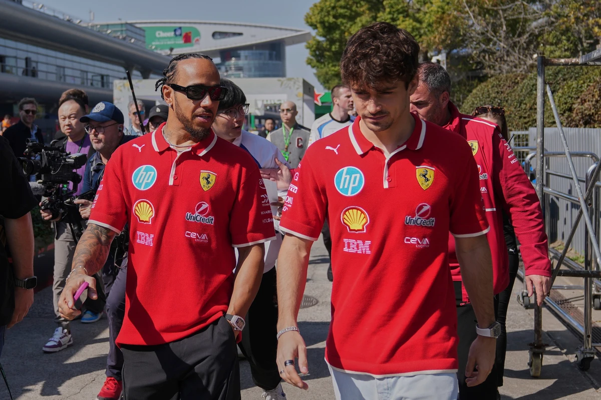 Ferrari driver Lewis Hamilton of Britain, left, chats with his teammate Charles Leclerc of Monaco as they walk out from their team’s hospitality suite ahead of the Chinese Formula One Grand Prix, in Shanghai, Friday. (AP)