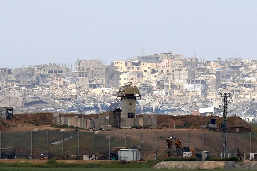 A military watch tower stands along Israel’s southern border with the northern Gaza Strip, backdropped by destroyed buildings on March 20, 2025. (AFP)