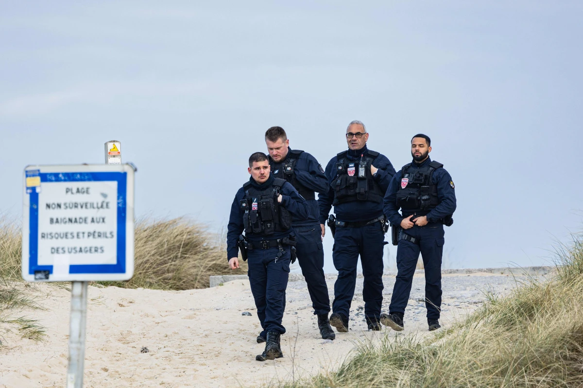 French Republican Security Corps (CRS — Compagnies Republicaines de Securite) police officers patrol the beach of Sangatte in order to prevent migrants from trying to cross the English Channel in Sangatte, northern France on March 20, 2025. (AFP)