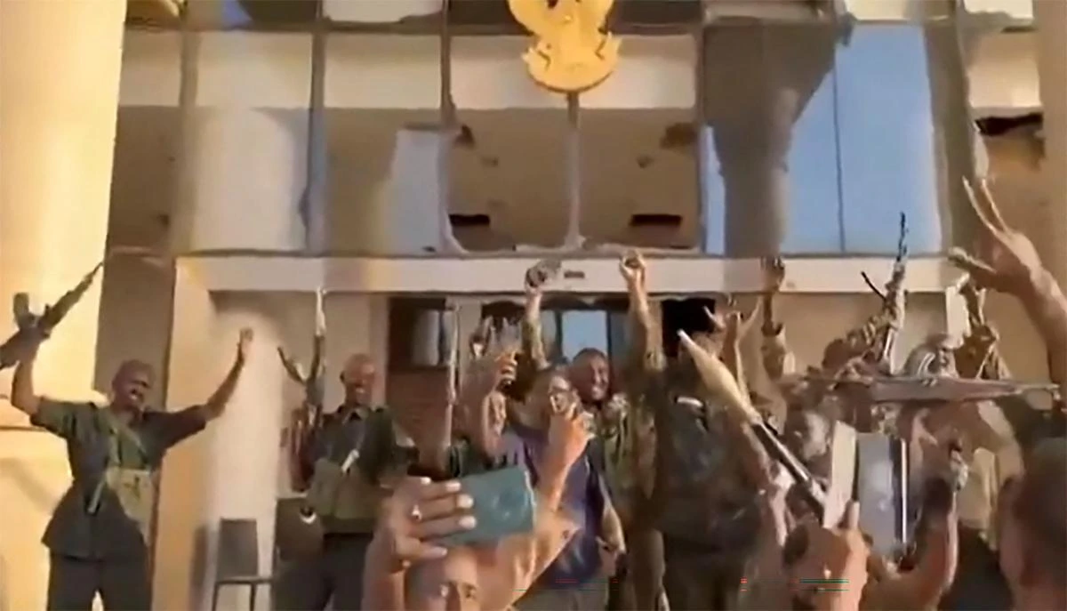 This image grab from a UGC video posted on March 21, 2025 shows Sudanese soldiers celebrating after retaking the presidential palace in Khartoum from paramilitaries. (AFP)