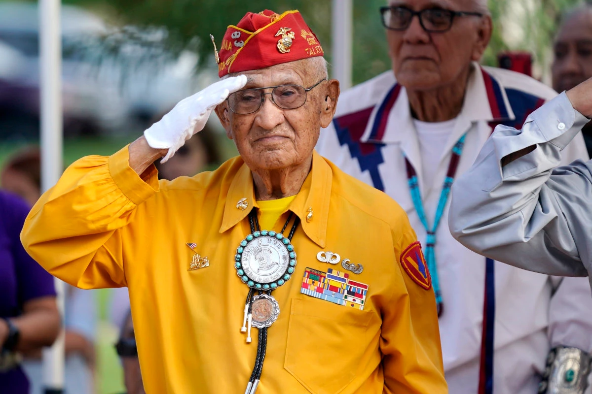 Navajo Code Talker Thomas Begay salutes during the national anthem at the Arizona State Navajo Code Talkers Day celebration on Aug. 14, 2022, in Phoenix. (AP Photo/File)