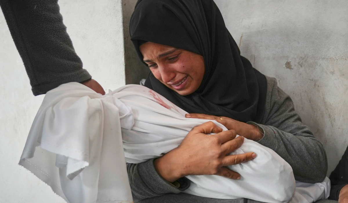 Amani Abu Aker holds the body of her two-year-old niece Salma, killed during an Israeli army strike, before their burial at the Baptist hospital in Gaza City, Monday March 24, 2025. (AP)