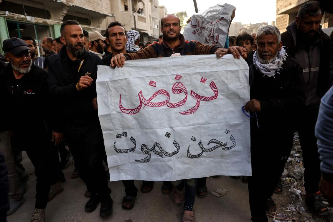 A man carries a sign reading in Arabic: "We refuse to die" during a rally calling for an end to the war, in Beit Lahia, in the northern Gaza Strip, Mar. 25, 2025. (AFP)