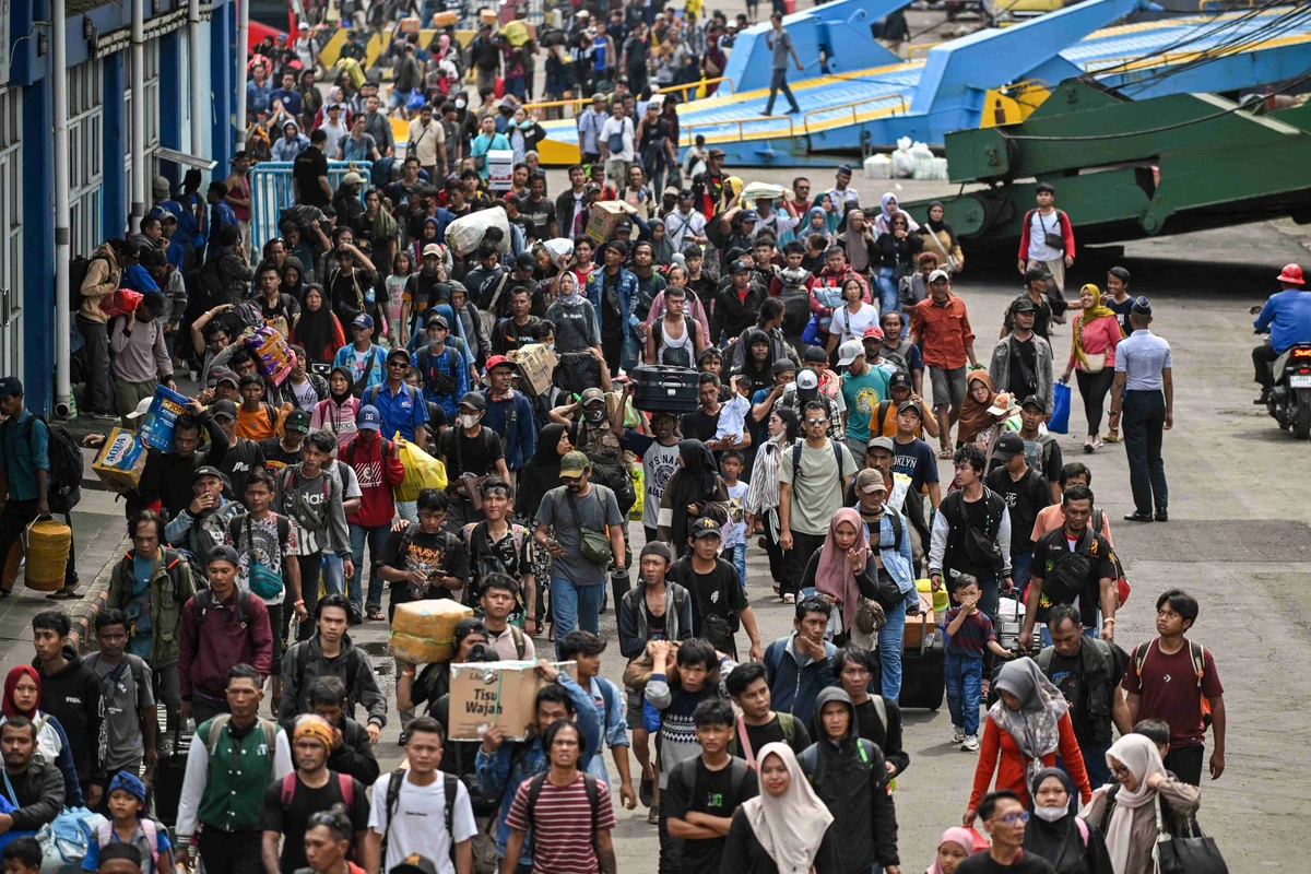 Passengers disembark from a ship at the Perak seaport in Surabaya on March 25, 2025, as people travel to their hometowns ahead of Eid Al-Fitr. (AFP)