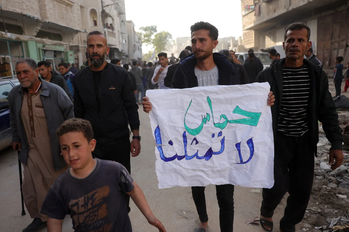 A Palestinian youth carries a banner that reads in Arabic, "Hamas does not represent us," during a protest calling for an end to the war with Israel in Beit Lahia, Gaza Strip, Mar. 26, 2025. (AFP)