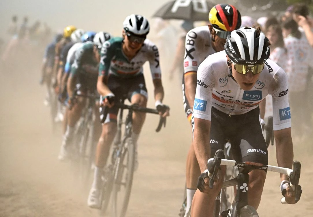 UAE Team Emirates team’s Slovenian rider Tadej Pogacar wearing the best young rider’s white jersey (R) cycles across a cobblestone sector with the pack of riders during the 5th stage of the 109th edition of the Tour de France cycling race, between Lille and Arenberg Porte du Hainaut, in France, in 2022. (AFP/File)