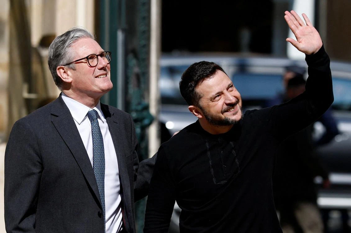 British Prime Minister Keir Starmer and Ukraine’s President Volodymyr Zelensky react after a meeting at the British embassy on the sideline of a summit for “coalition of the willing” in Paris, on Mar. 27, 2025. (AFP)