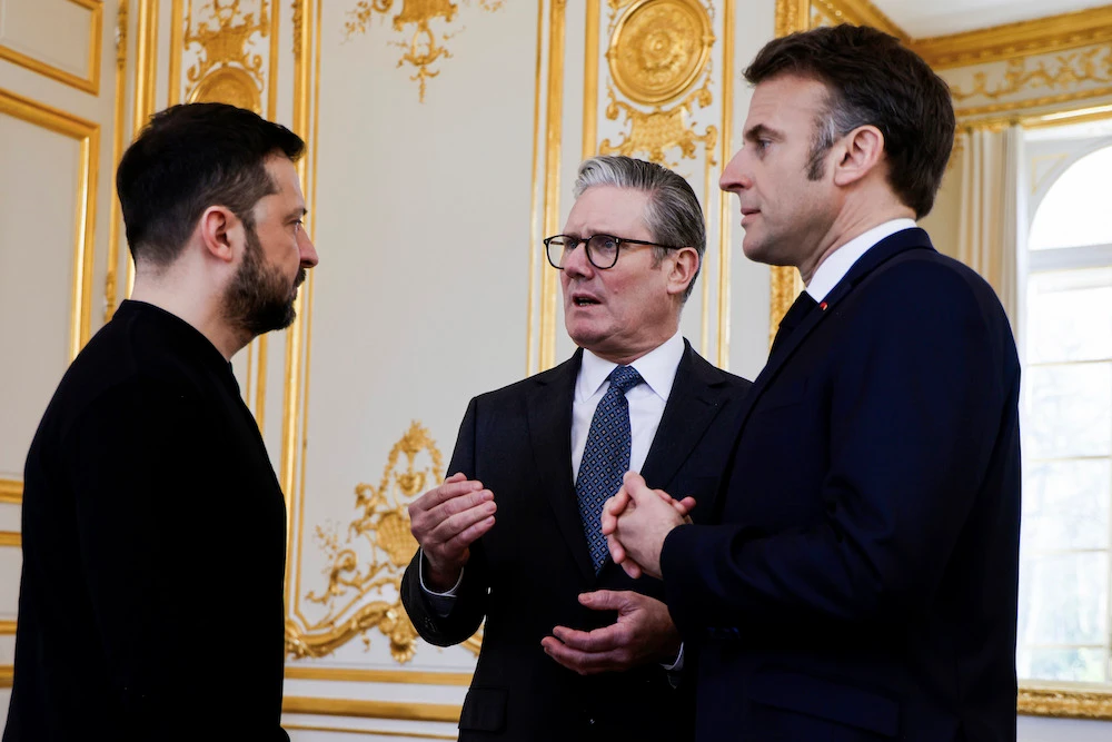 Ukraine’s President Volodymyr Zelensky, left, French President Emmanuel Macron, right, and Britain’s Prime Minister Keir Starmer speak during a trilateral meeting on the sidelines of a summit for “coalition of the willing” at the Elysee Palace, Thursday, March 27, 2025. (AP)