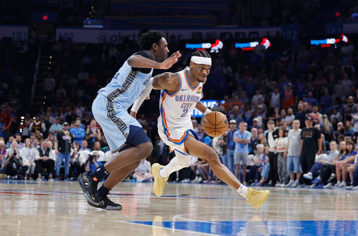 Oklahoma City Thunder guard Shai Gilgeous-Alexander drives around Memphis Grizzlies guard Vince Williams Jr. during the second quarter of an NBA game at Paycom Center Thusrsday. (Alonzo Adams-Imagn Images)