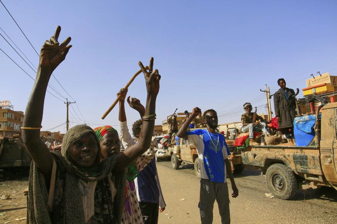 Local resident cheer as soldiers arrive to the Allafah market, in an area recently recaptured by Sudan’s army from the Rapid Support Forces paramilitary group, in the Al Kalalah district, 40km south of Khartoum, Sudan, Thursday, March 27, 2025. (AP Photo)