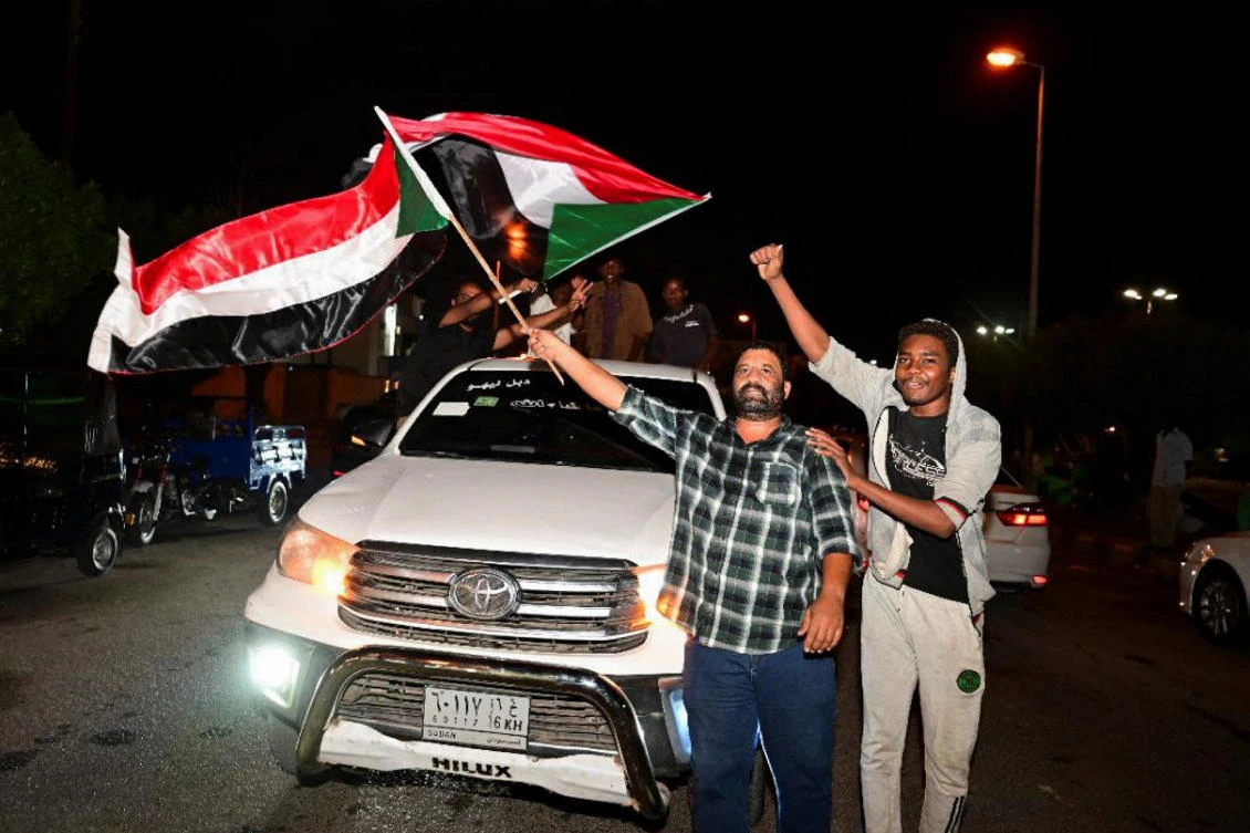 Sudanese citizens celebrate on a street after the Sudanese army deepened its control over the capital Khartoum, from the Rapid Support Forces (RSF), in Port Sudan, Mar. 27, 2025. (Reuters)