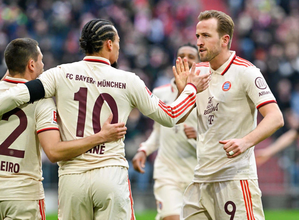 Bayern Munich’s Leroy Sane, and teammate Harry Kane high five as they celebrate after Sane scored their second goal of the game during their Bundesliga match against St. Pauli, at the Allianz Arena stadium in Munich, Mar. 29, 2025. (AP)