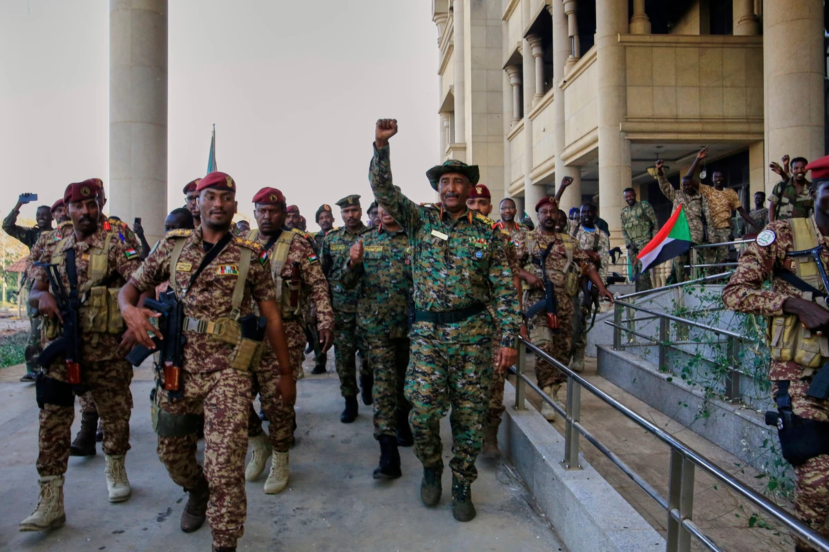 Sudan's military chief Gen. Abdel-Fattah Burhan, center, is greeted by troops as he arrives at the Republican Palace, recently recaptured from the Rapid Support Forces paramilitary group, in Khartoum on March 26, 2025. (AP Photo)