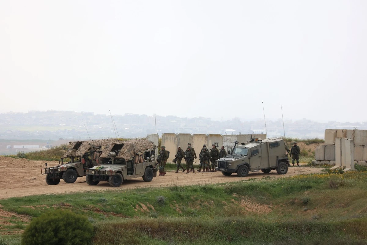 Israeli army soldiers walk in a position along Israel's southern border (AFP)