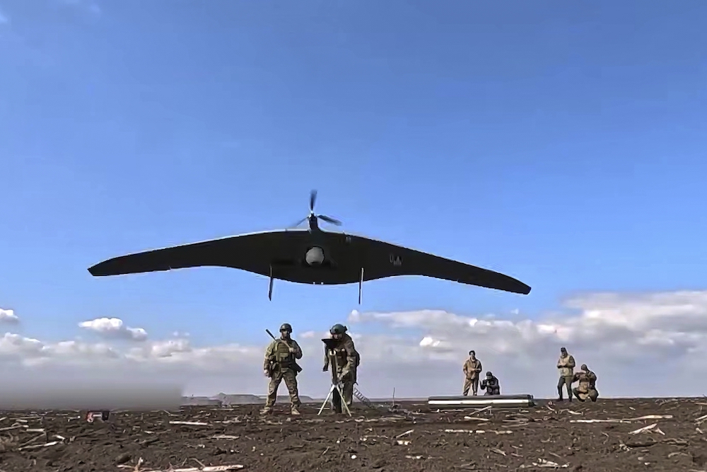 Russian soldiers launch a Supercam intelligence unmanned aerial vehicle towards Ukrainian positions. (AP)