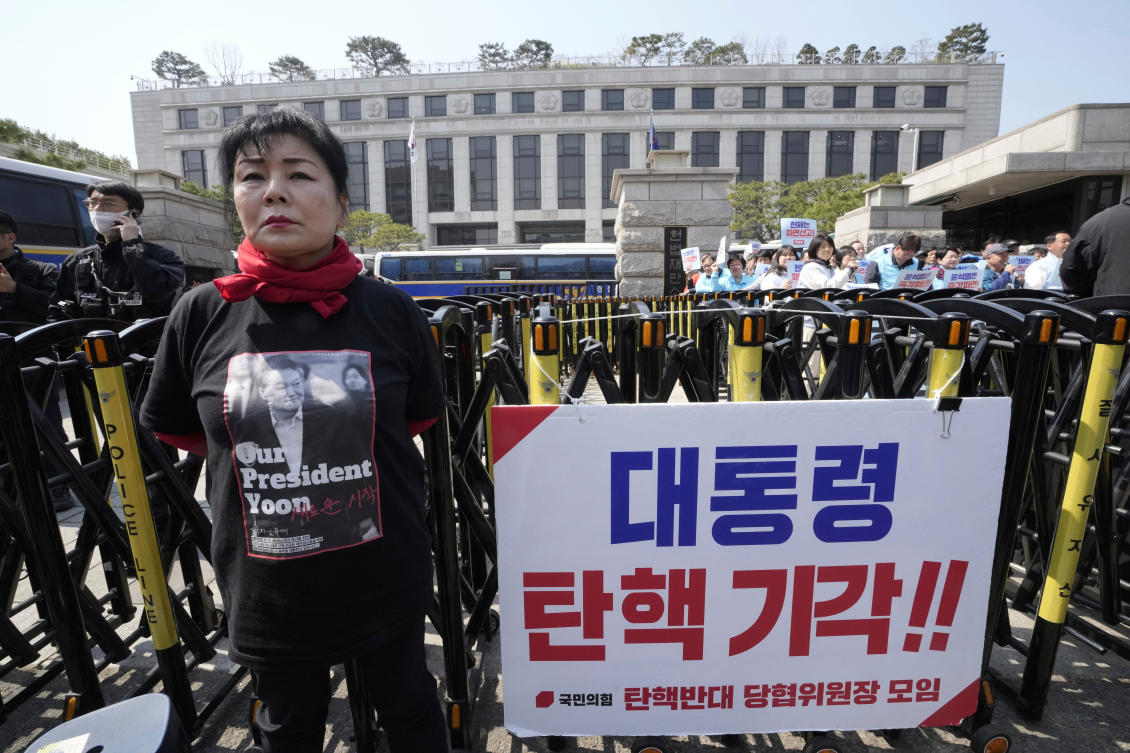Above, supporters of impeached South Korean President Yoon Suk Yeol in front of the Constitutional Court in Seoul on April 1, 2025. The banner reads “Dismiss impeachment.” (AP)