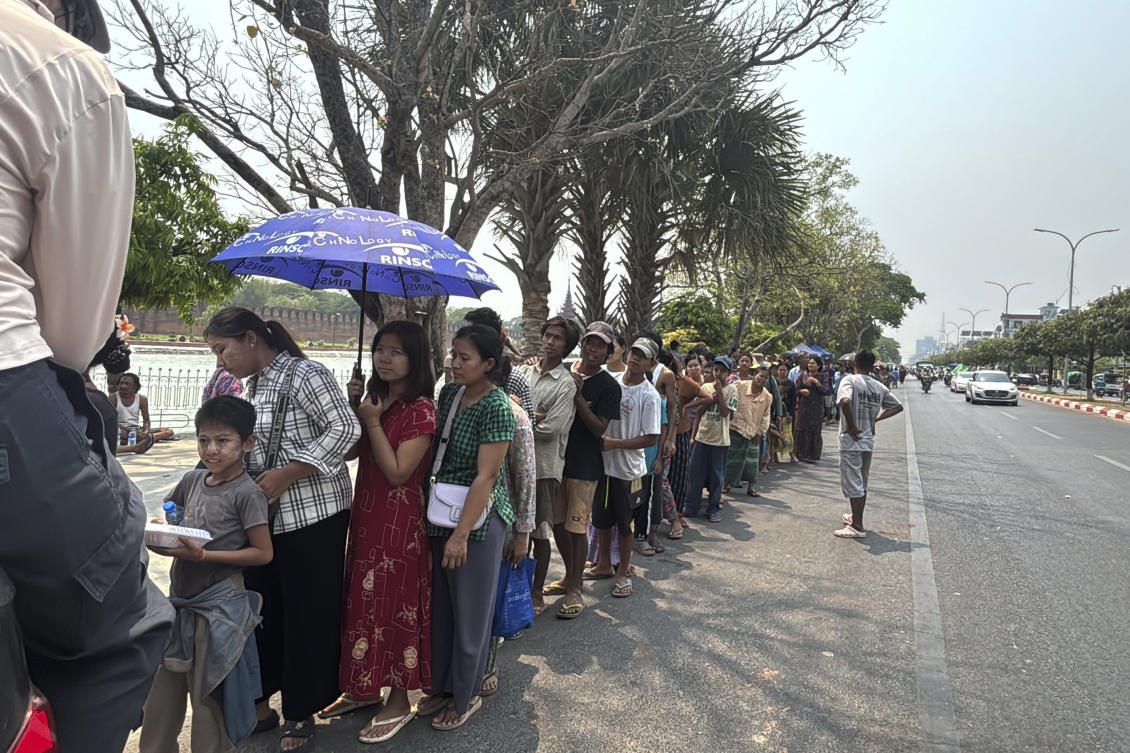 People line up on a roadside for free food after their houses was damaged by Friday’s earthquake in Mandalay, Myanmar, Apr. 1, 2025. (AP)