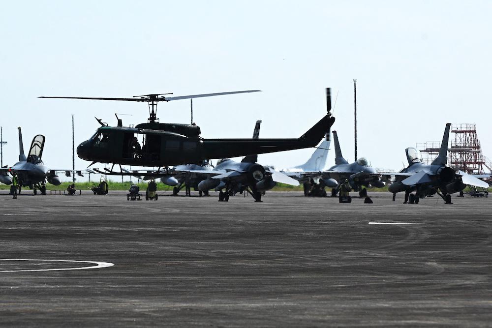 A Philippine Huey helicopter takes off past US F-16 fighter jets during the joint US-Philippines military exercise at the former American installation Clark air base in Pampanga on May 9, 2023. (AFP file photo)