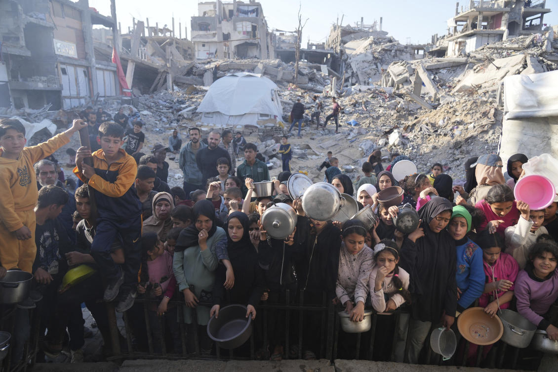 Palestinians wait for donated food at a distribution center in Beit Lahiya, northern Gaza Strip, Mar. 16, 2025. (AP/File)