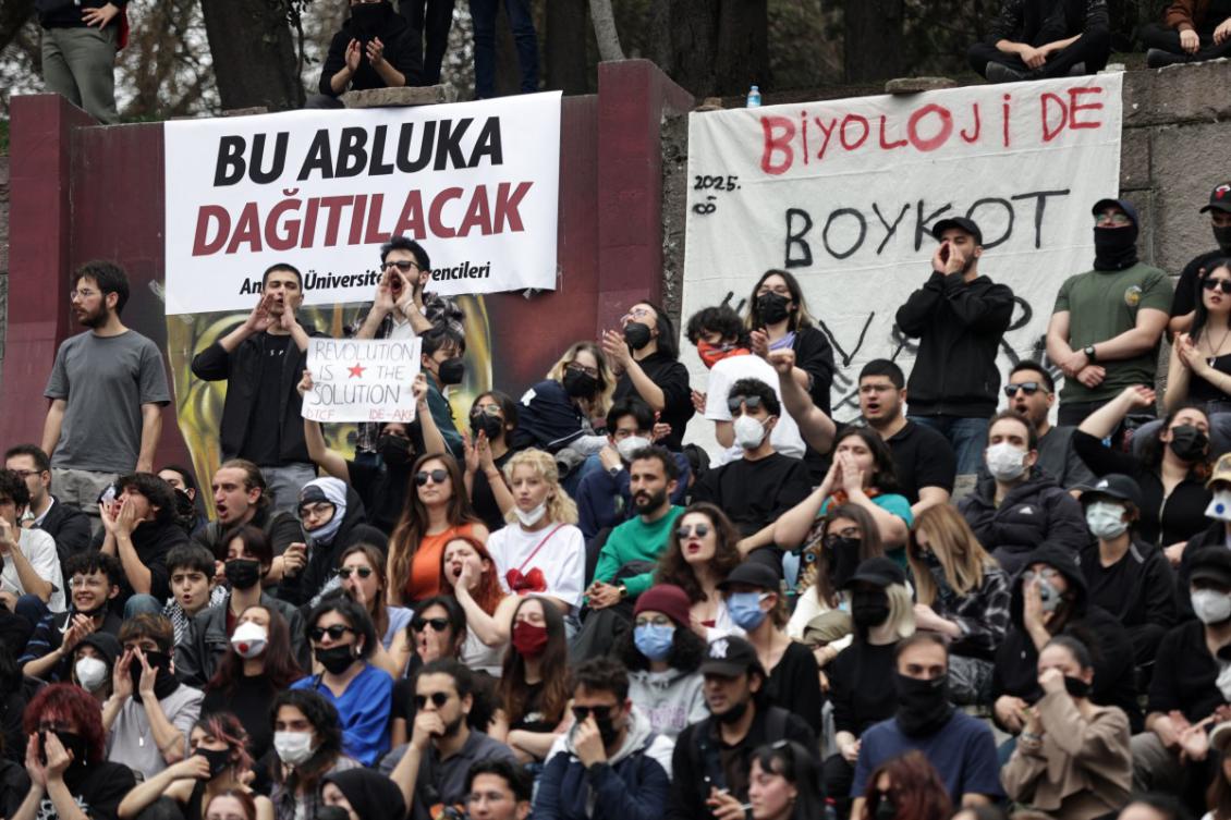 University students, next to banners reading "this blockade will be lifted" (L) and "Boycott at University" (R), take part in a rally in support of Istanbul mayor, nine days after his arrest, at Seymenler Park in Ankara, on March 28, 2025. (AFP)