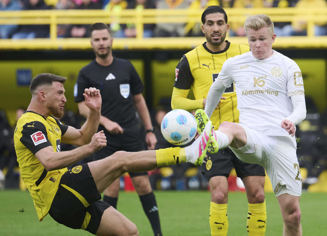 Dortmund’s Salih Ozcan and Mainz’s Jonathan Burkardt challenge for the ball during their Bundesliga match at Signal Iduna Park in Dortmund, Mar. 30, 2025. (AP)
