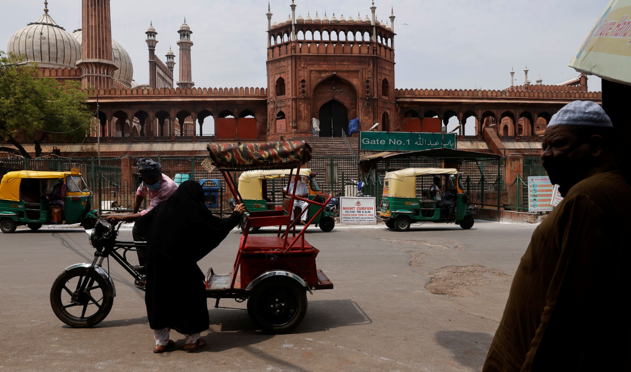 A woman sits in a rickshaw in front of Jama Masjid or Grand Mosque on Jumat-ul-Vida or the last Friday of the holy fasting month of Ramadan, during a lockdown to limit the spread of the coronavirus disease (COVID-19), in the old quarters of Delhi, India, May 7, 2021. (REUTERS)