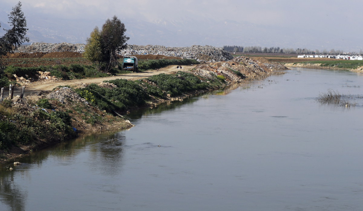 Waste is pictured in the waters of the Litani River as it crosses by the village of Jib Jannine in the southern Bekaa Valley on May 4, 2019. (AFP)