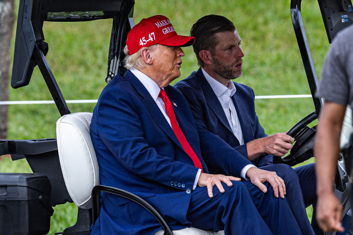 US President Donald Trump and his son Eric Trump drive in a golf cart after arriving in Marine One on the ninth hole at Trump National Doral Miami on April 03, 2025 in Doral, Florida. (Getty Images via AFP)