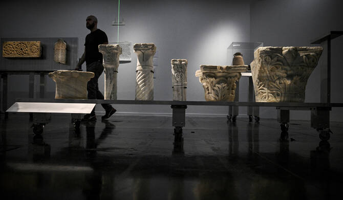 A man walks among the antiques during the installation of the archaeological heritage exhibition “Treasures saved from Gaza — 5000 years of history” (Tresors sauves de Gaza — 5000 ans d’histoire) at the Institut du Monde Arabe, in Paris on March 31, 2025. (AFP)