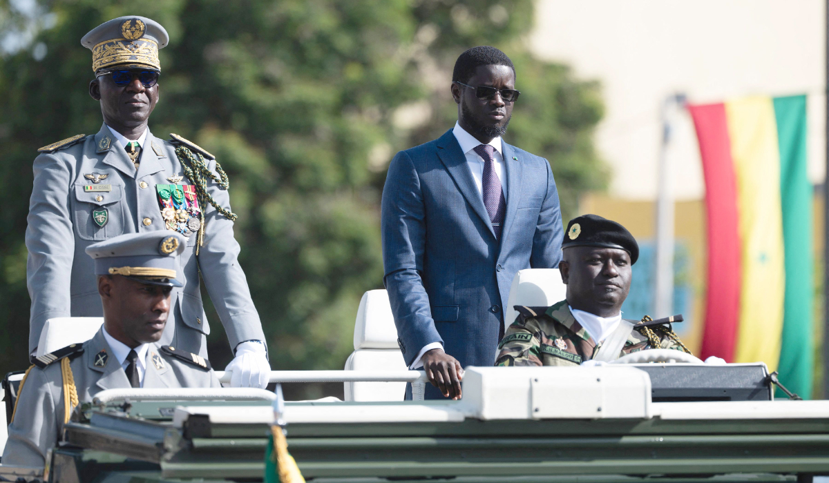 Senegal's President Bassirou Diomaye Faye (2nd R) and Senegal's Chief of General Staff Mbaye Cisse (2nd L), ride on a military vehicle to review the troops during the 65th Independence Day parade on Boulevard General de Gaulle, now Boulevard Mamadou Dia, in Dakar on on April 4, 2025. (AFP)
